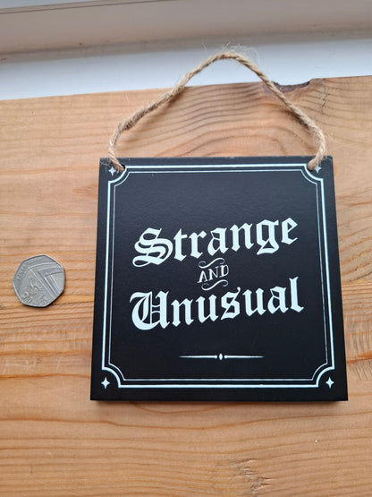 Strange and Unusual Small Sign